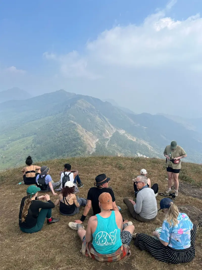 Retreat group resting on a hilltop looking out over mountain ridges
